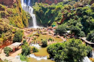 Ouzoud Falls in Morocco, showcasing cascading waterfalls and lush greenery.